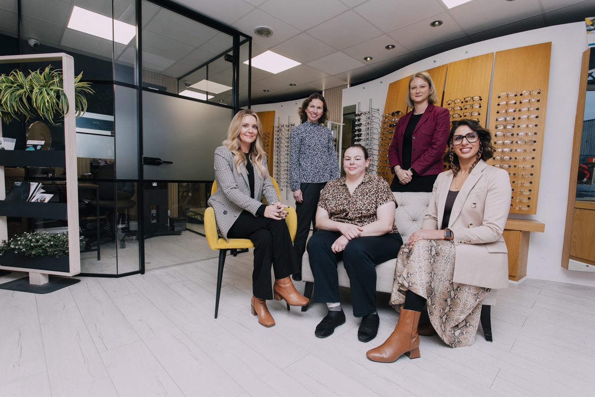 the richard petrie team are posing in the reception area